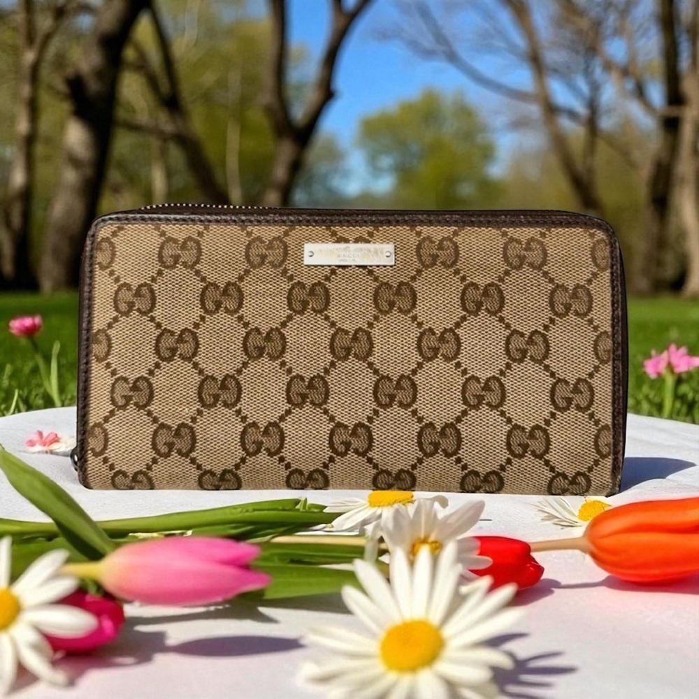 - GUCCI Monogram Metal Bar Zip Around
Wallet. Some wear on edges .